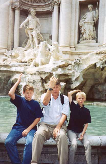 Sean McQueen, Jim McQueen, and Scott McQueen throw coins into Trevi Fountain, Rome